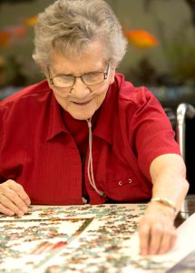 Woman putting puzzle together.